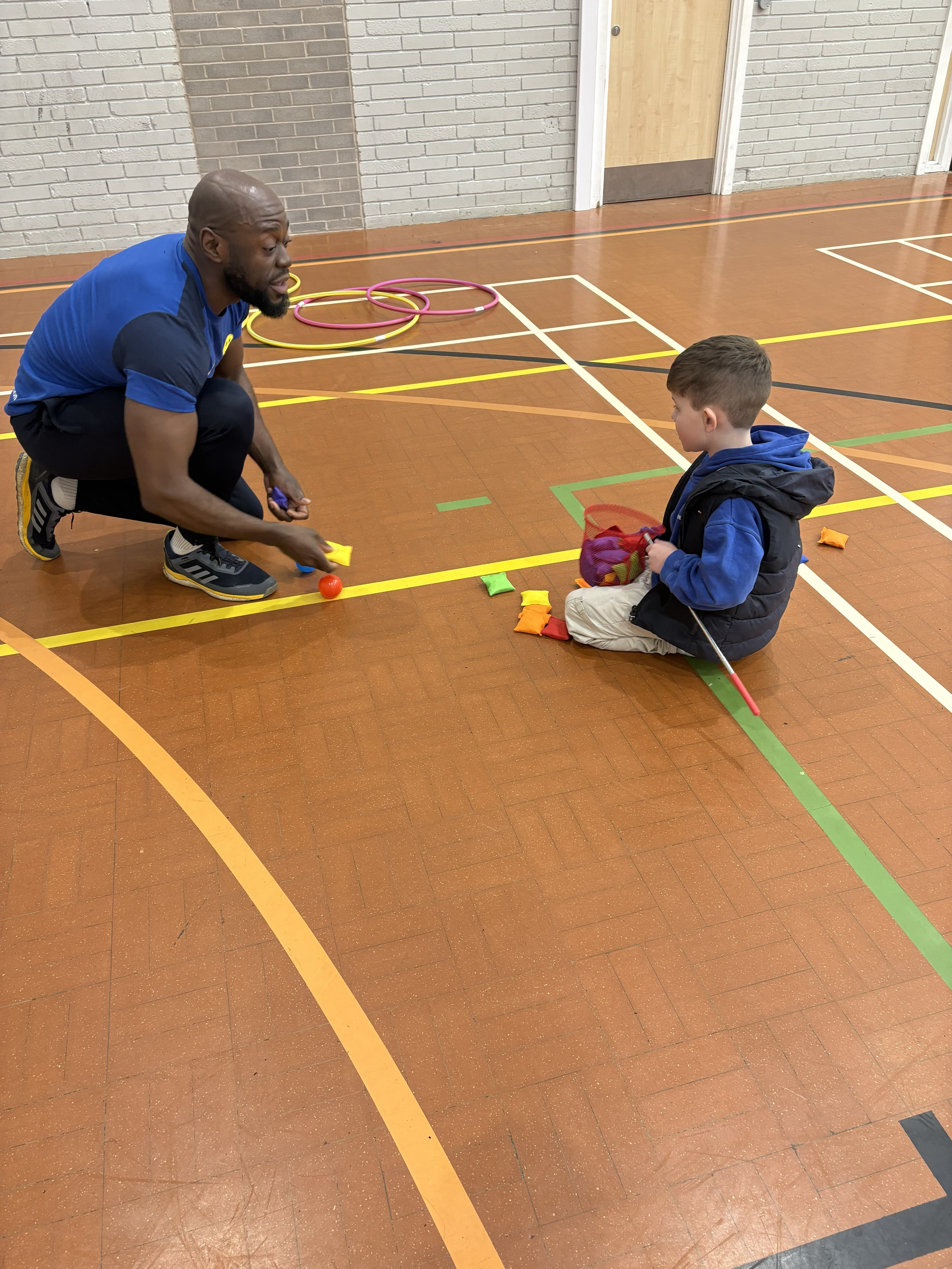 Coach supporting a pupil through an agility drill